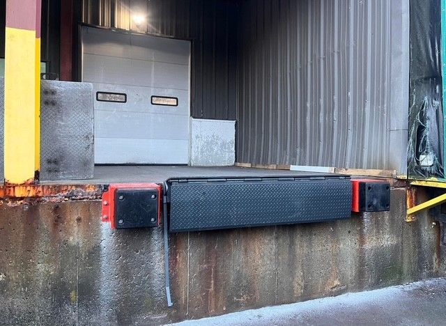 A warehouse with a loading dock and a garage door