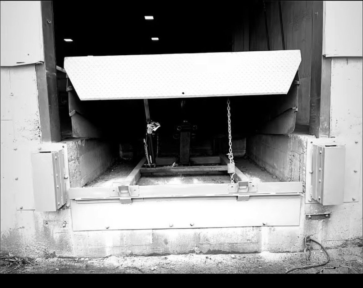 A black and white photo of a loading dock with the door open