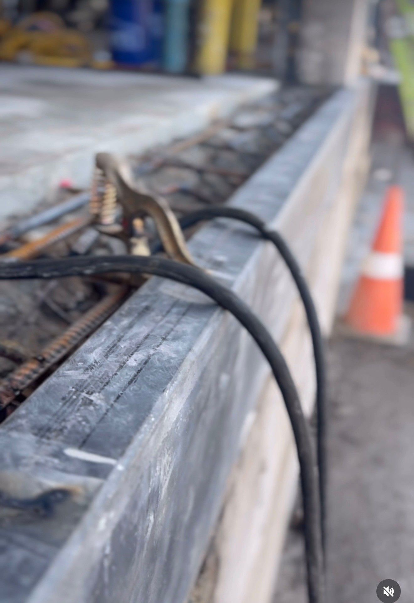 A close up of a welding machine on  a concrete surface