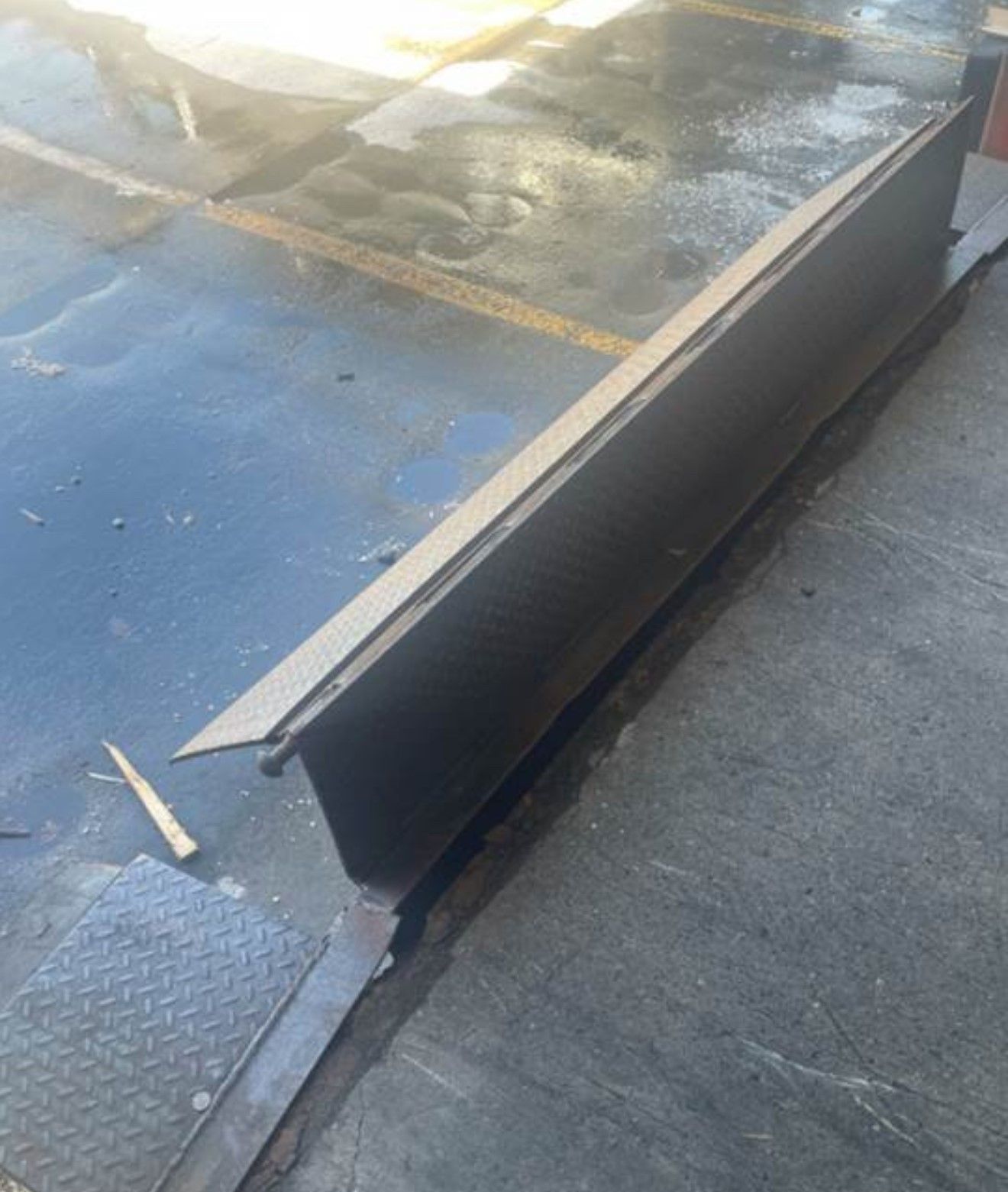 Loading dock overhead door with a loose metal ramp