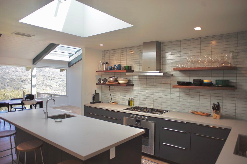 A kitchen with a skylight above the stove and a large island.