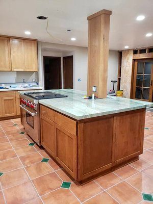 A kitchen with a large island in the middle of it.