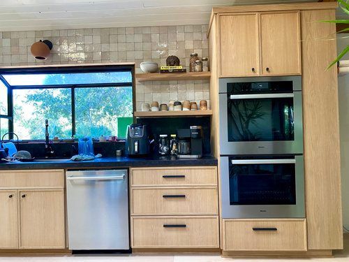 A kitchen with stainless steel appliances and wooden cabinets