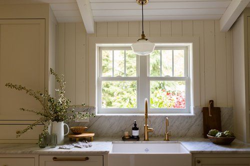 A kitchen with a sink and a window.