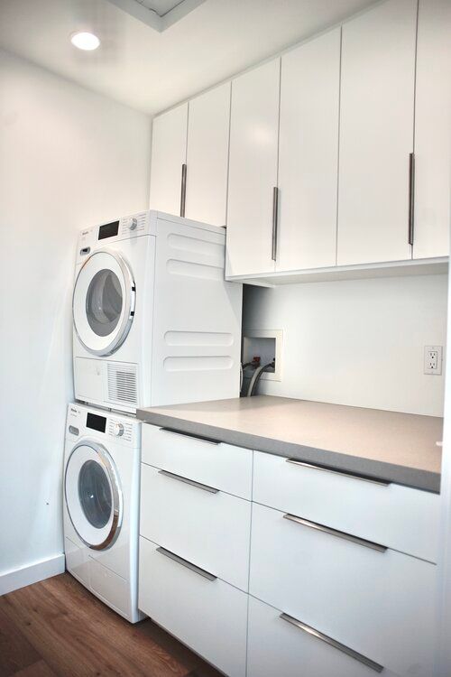 A laundry room with a washer and dryer stacked on top of each other.