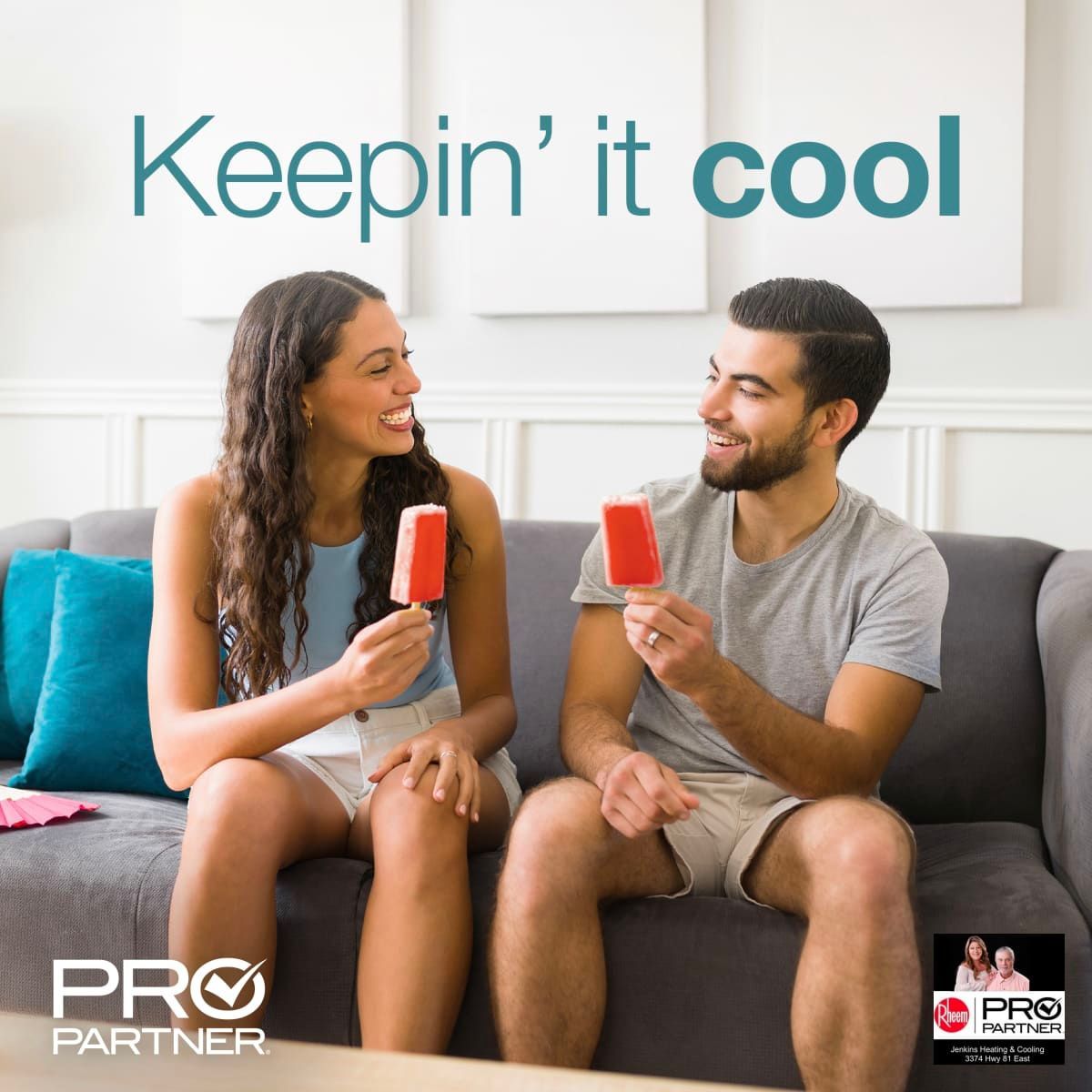A man and a woman are sitting on a couch eating popsicles.