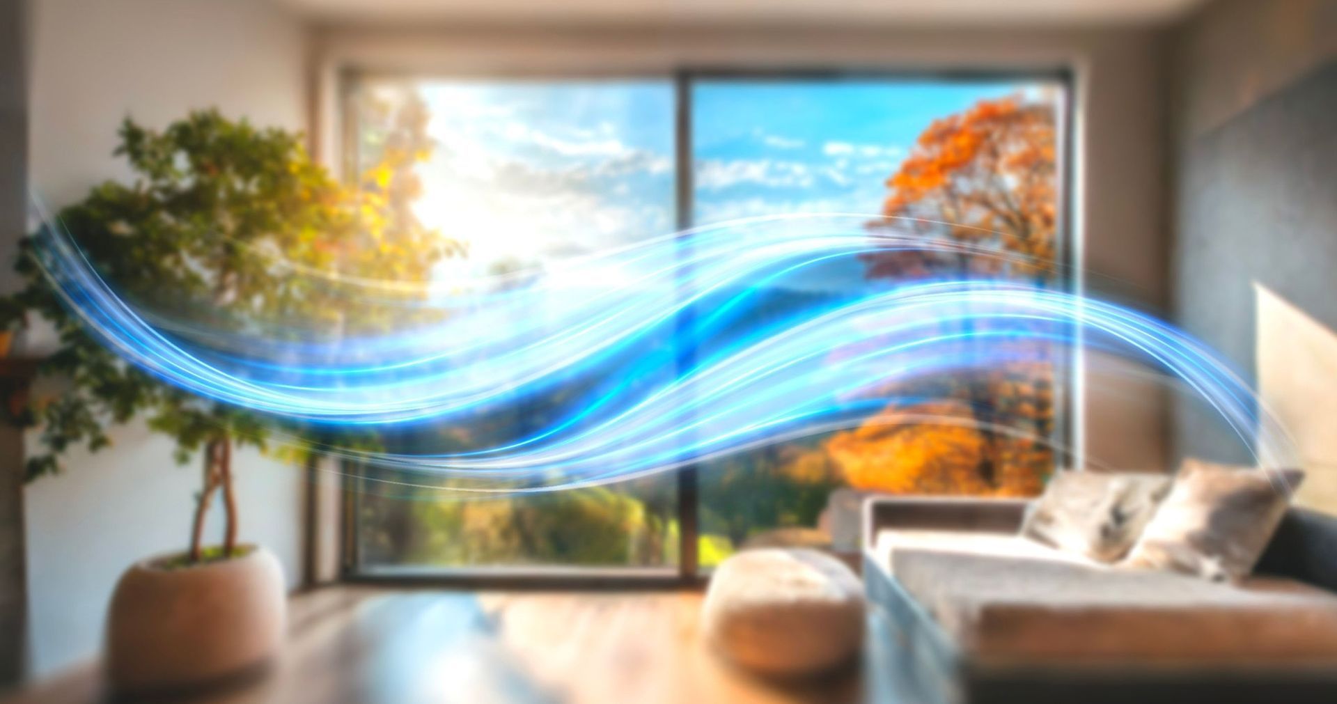 White air purifier next to person on a couch using a laptop.