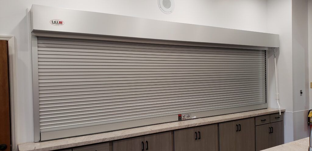 a kitchen with a stainless steel shutter on the wall