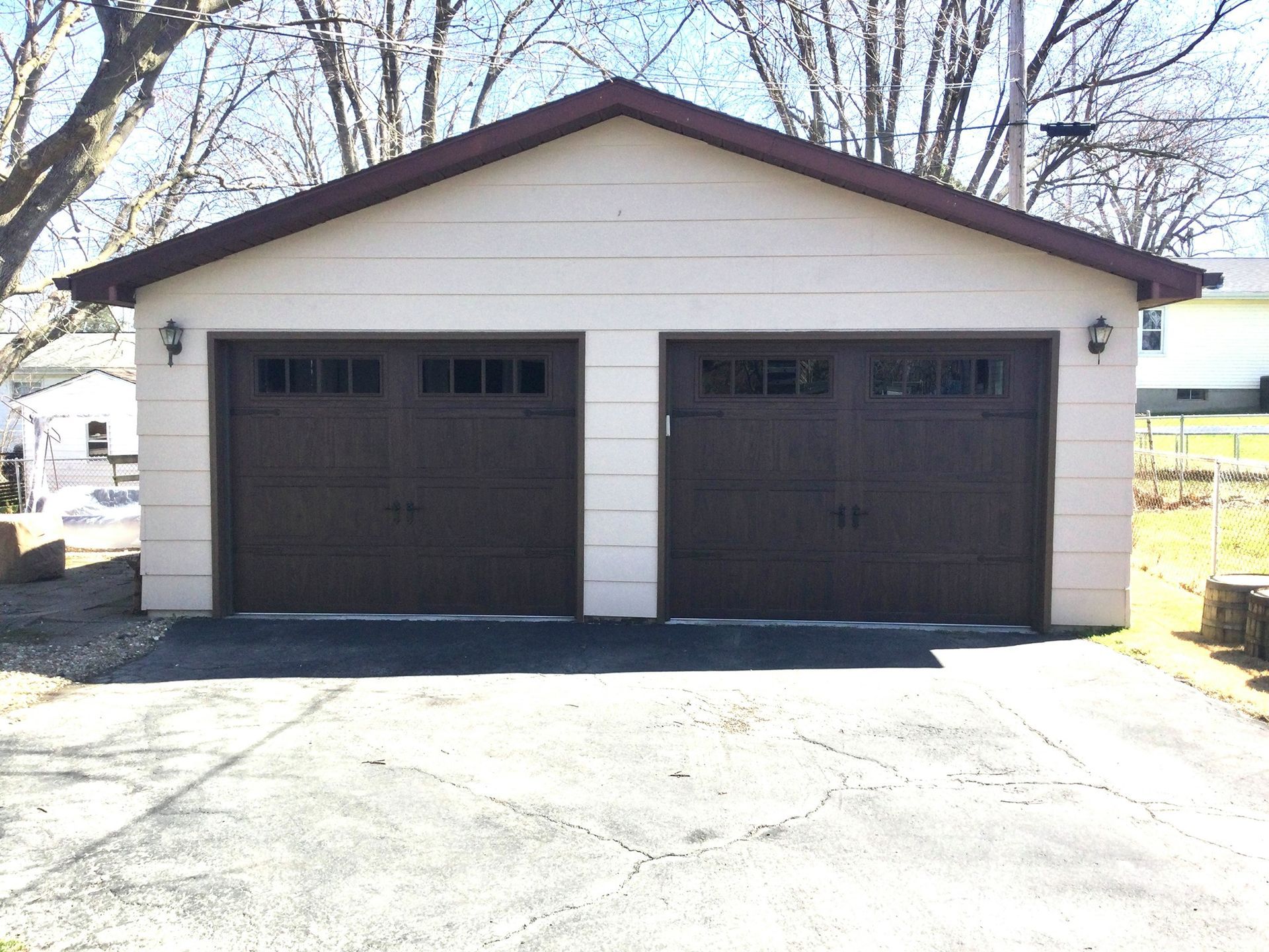 a garage with two brown doors and a brown roof