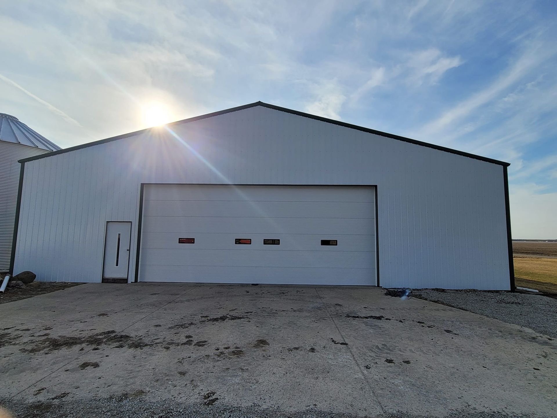 a large white building with a large garage door