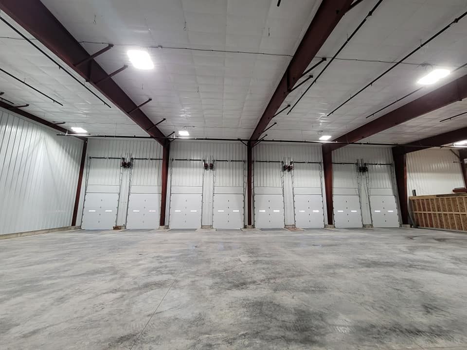 a large warehouse with a lot of doors and a concrete floor