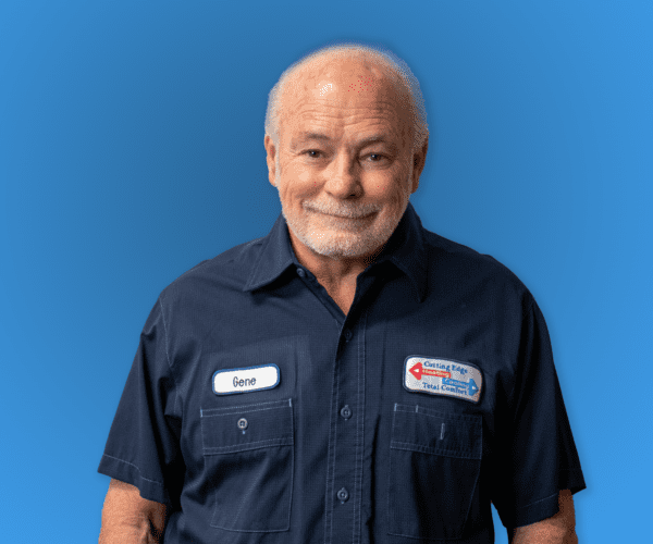Smiling man in navy work shirt with name tag against a blue background