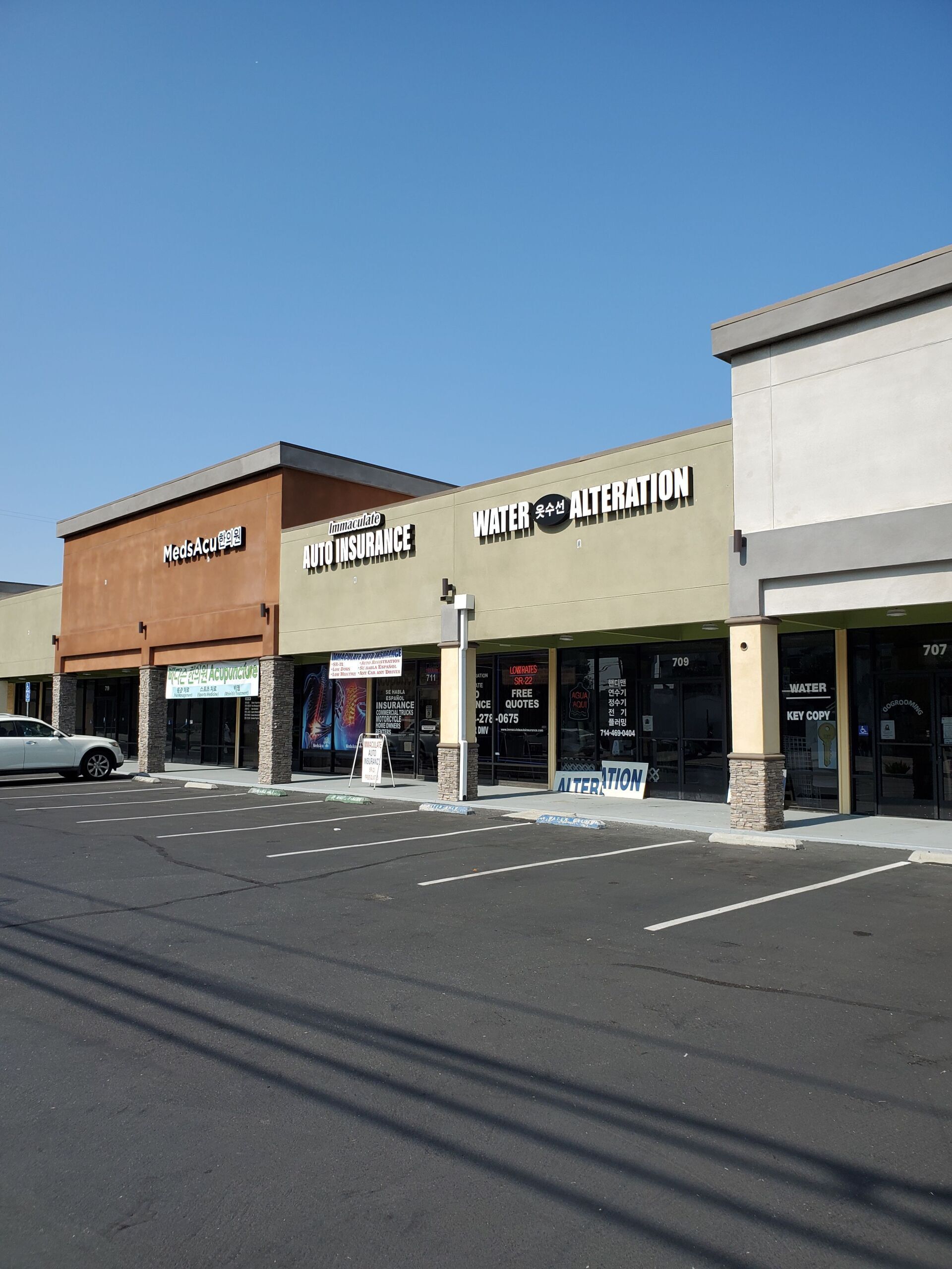 A row of stores with one that says welcome center