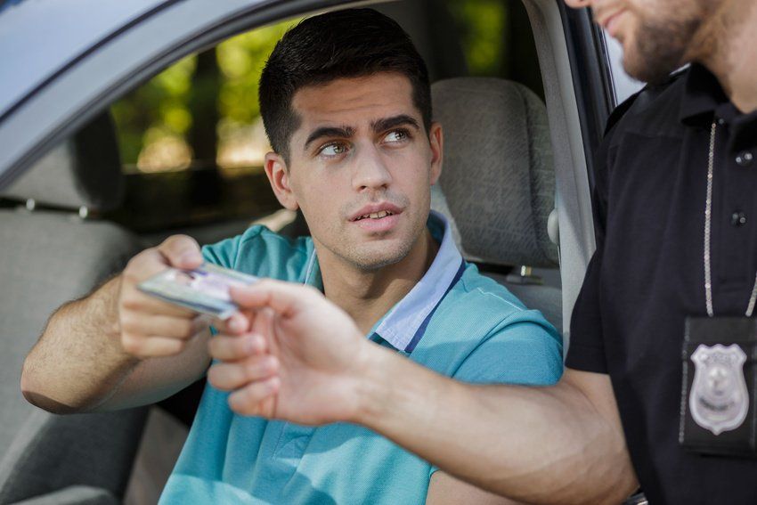 Police officer giving back documents to young man