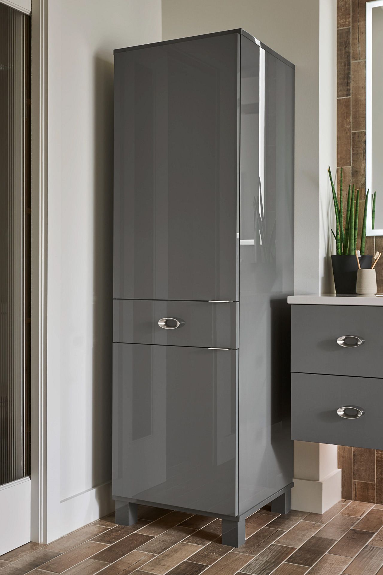 A bathroom with a gray cabinet and a gray vanity.
