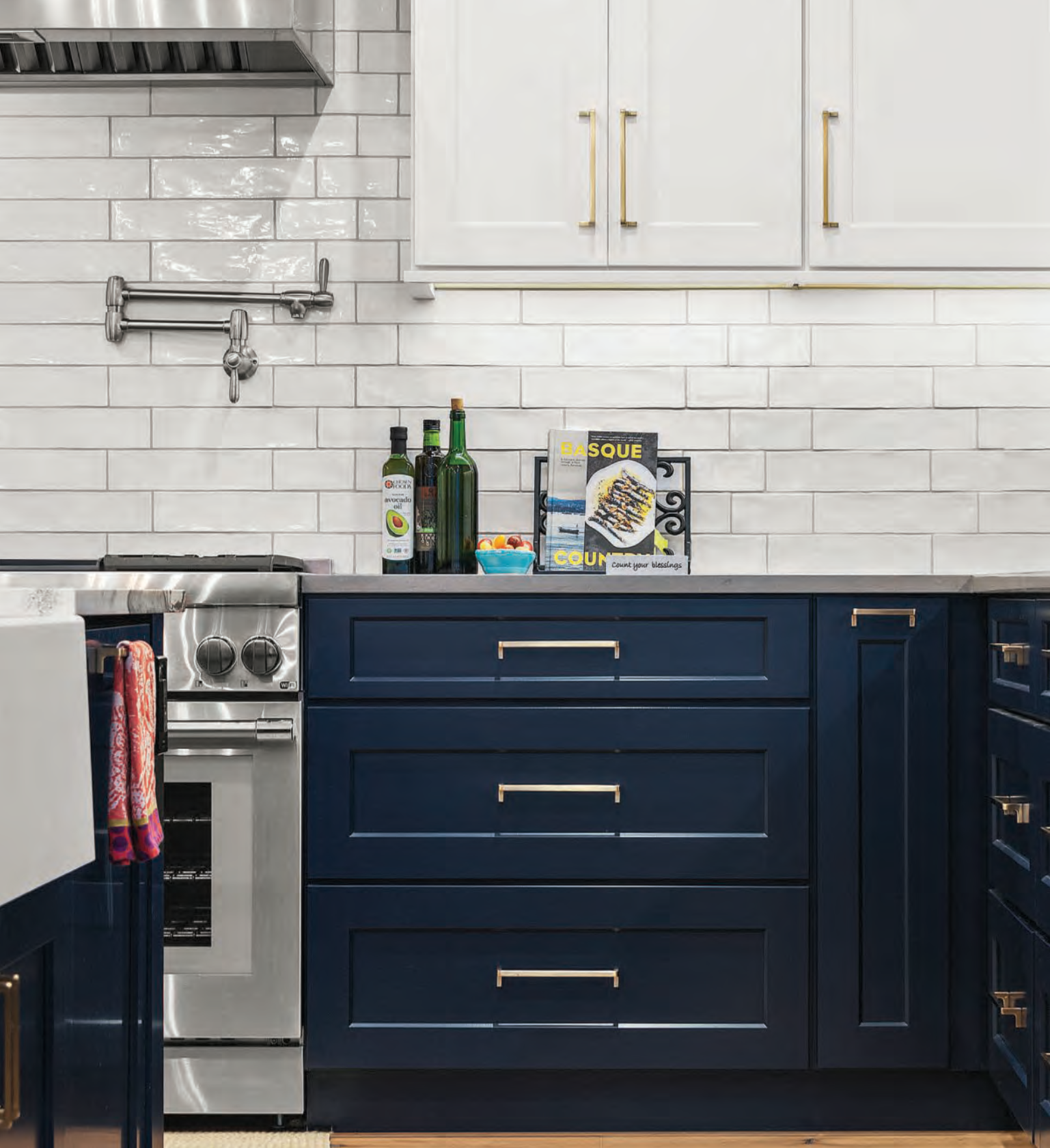 A kitchen with blue cabinets and a stove top oven