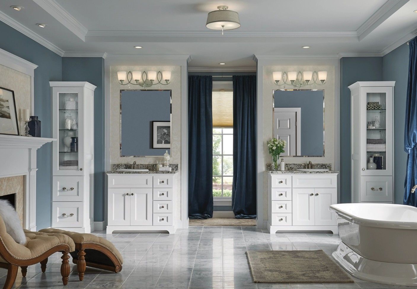 A luxurious master bathroom with two white vanities, blue walls, a bathtub, and a chaise lounge on a stone floor.