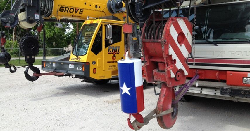 Two grove trucks are parked next to each other