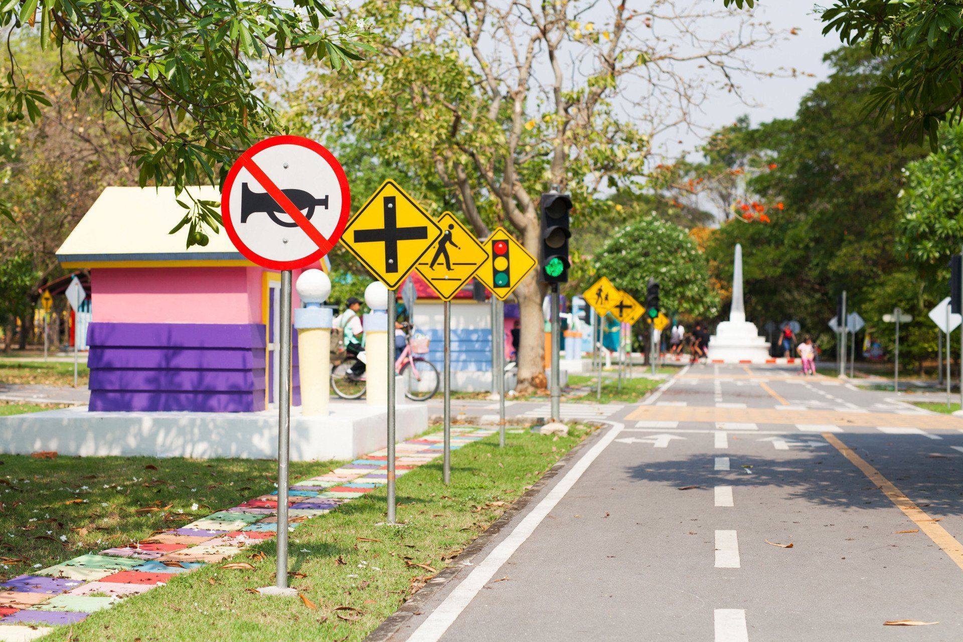 A row of street signs on the side of a road