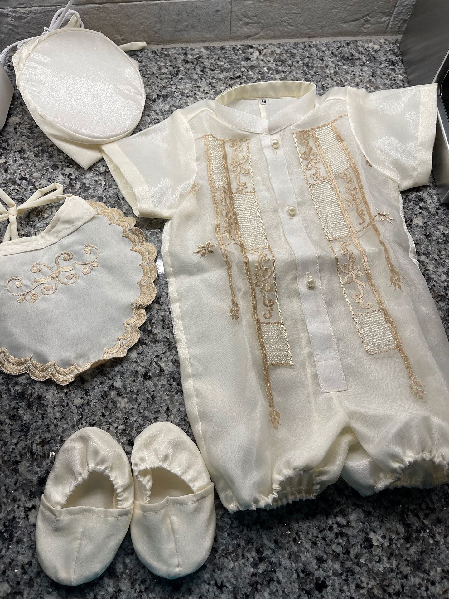 A set of baby christening clothes