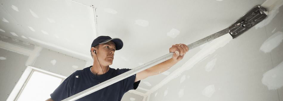 Carpenter installing a drywall