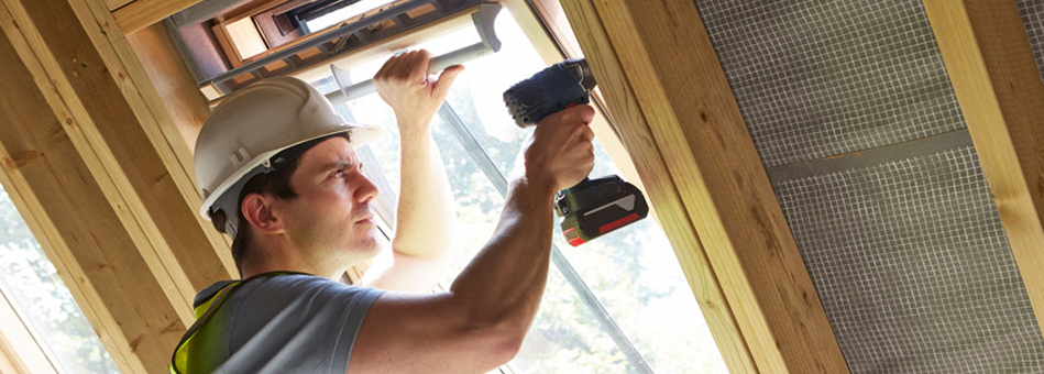 Carpenter installing a window
