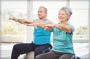 Learn More About Customized Medical Fitness Senior man and woman doing exercises