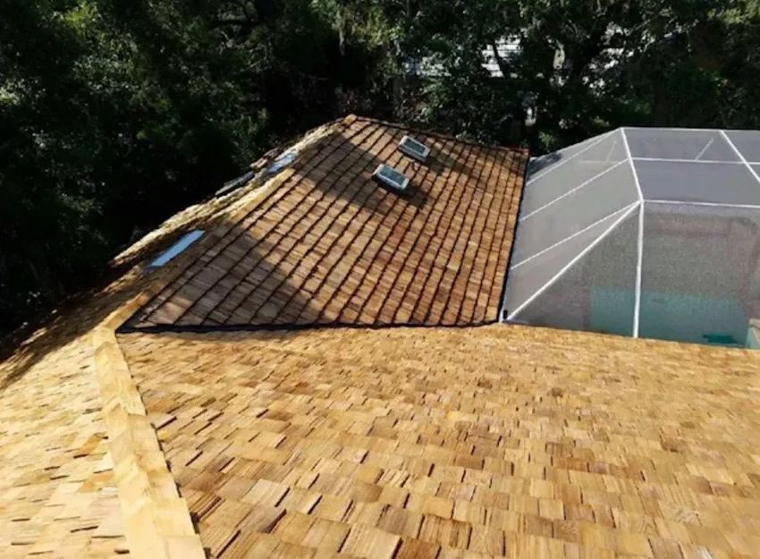 A wooden roof with a swimming pool in the background.
