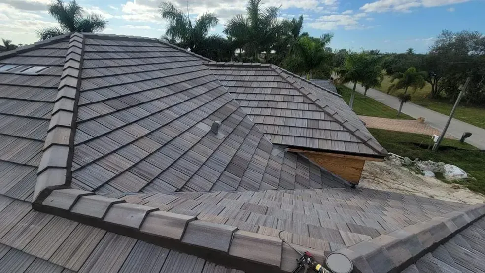 A roof with a lot of tiles on it and trees in the background.
