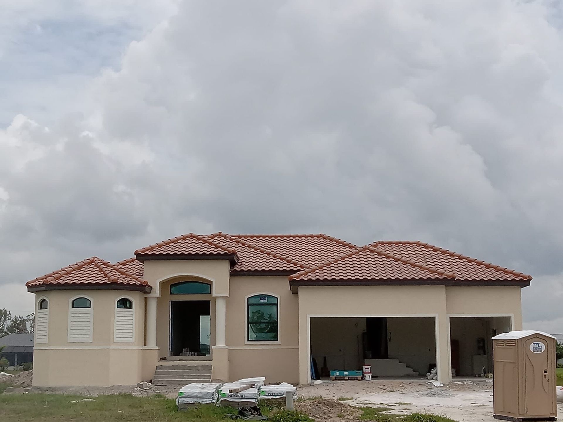 A house under construction with a brown tile roof
