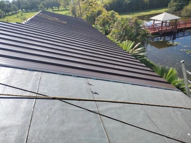 The roof of a house with a gazebo in the background