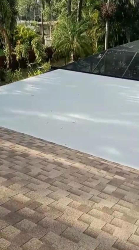 A white roof is sitting on top of a brick patio.