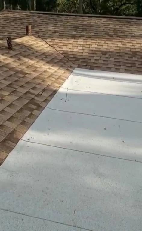 A close up of a roof with shingles and a white roof.