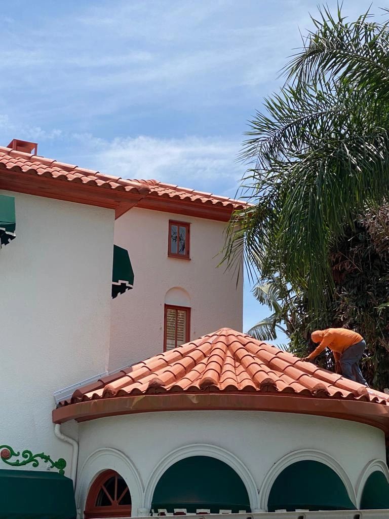 A man is working on the roof of a building.
