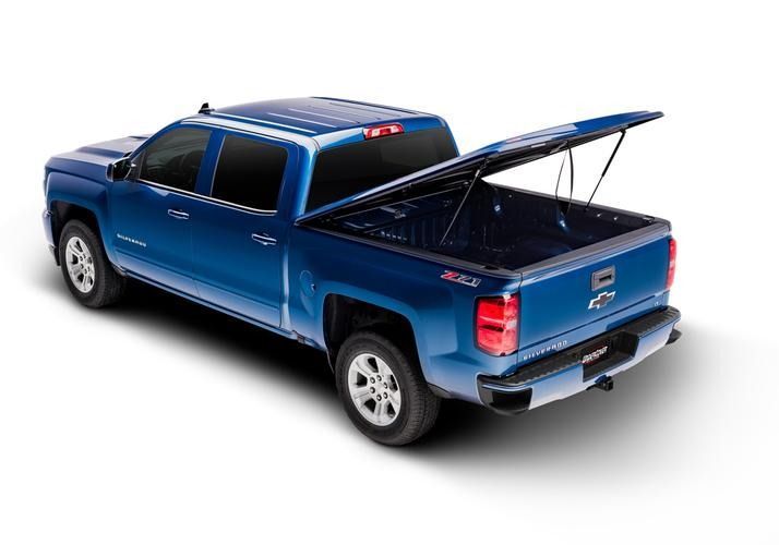 Blue pickup truck with the bed cover open, revealing the bed.