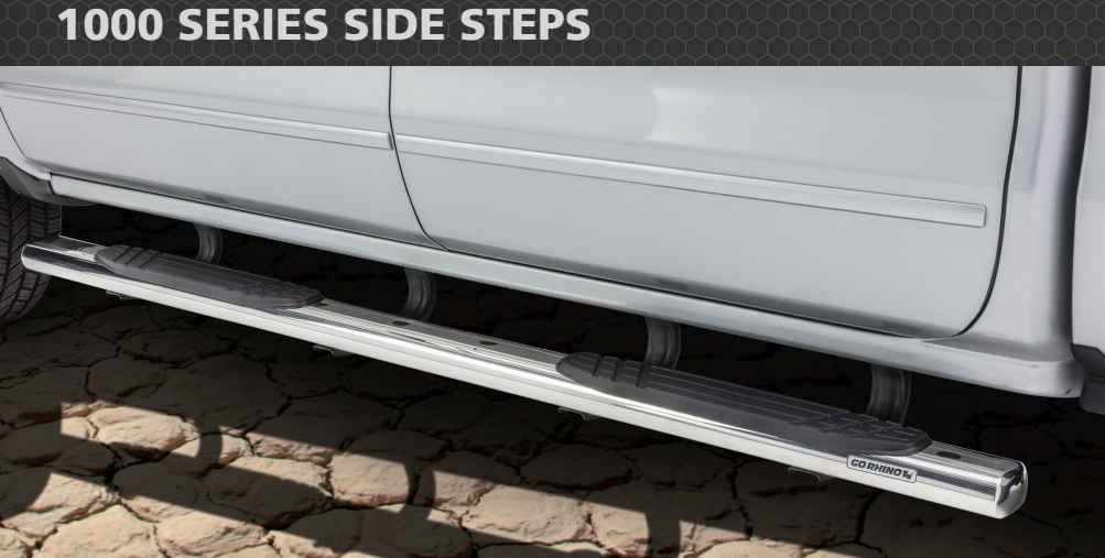 Silver truck side steps on a light-colored truck, with the text 