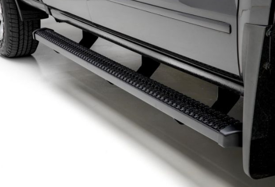 Black running board attached to a grey truck, providing a step for easier access.