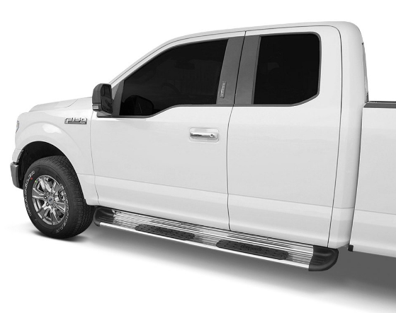 White pickup truck with silver running boards parked outdoors.