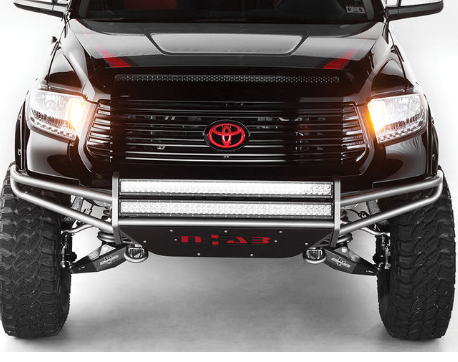 Black Toyota Tundra truck with off-road modifications, including a custom front bumper with LED lights, large tires, and red accents.