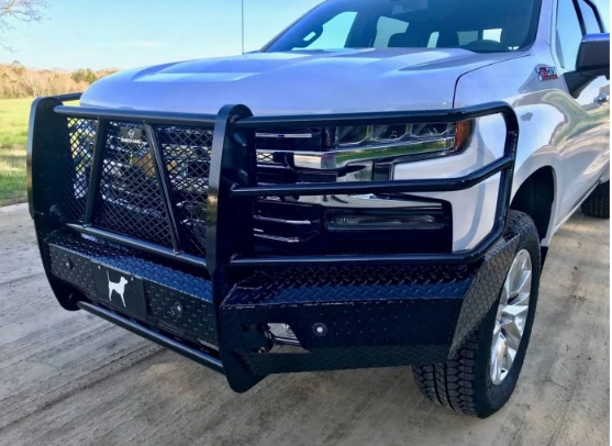 Silver pickup truck with a black bull bar bumper. The truck is parked outdoors on a concrete surface.