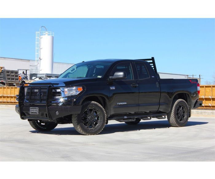 Black Toyota Tundra pickup truck with a black brush guard, black wheels, and a bed rack, parked outside on a sunny day.