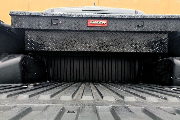 Black toolbox in a truck bed, with the 