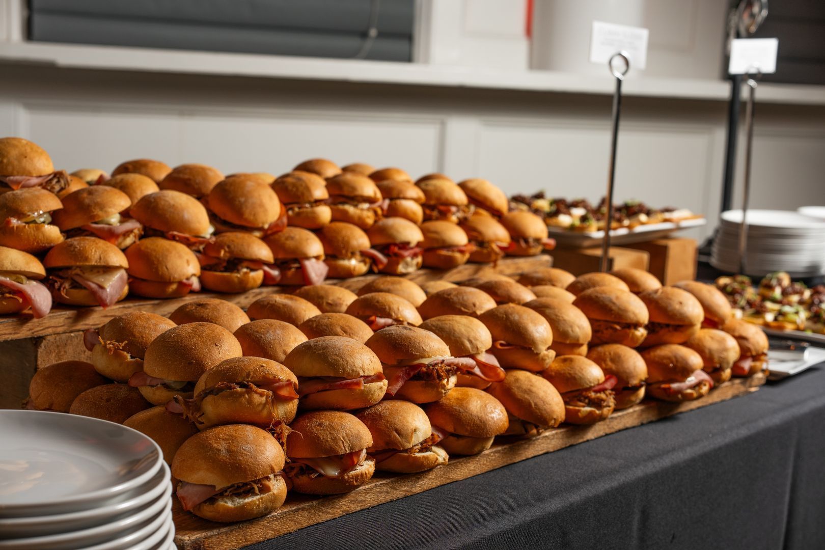 A bunch of sandwiches are stacked on top of each other on a table.