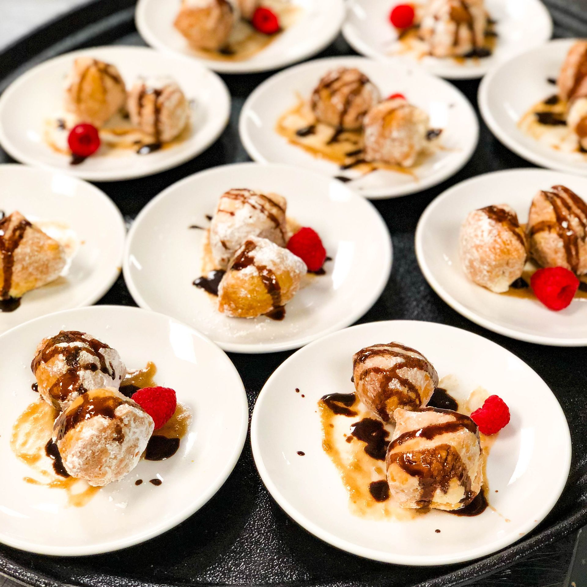 A bunch of white plates with desserts on them.