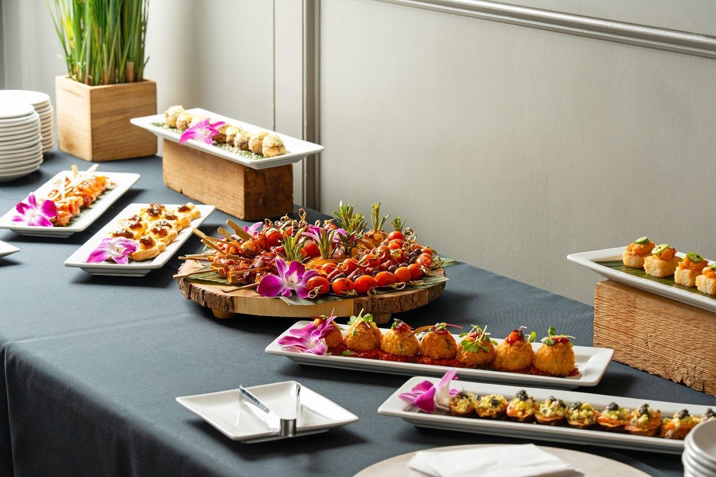A table topped with plates of food and flowers.