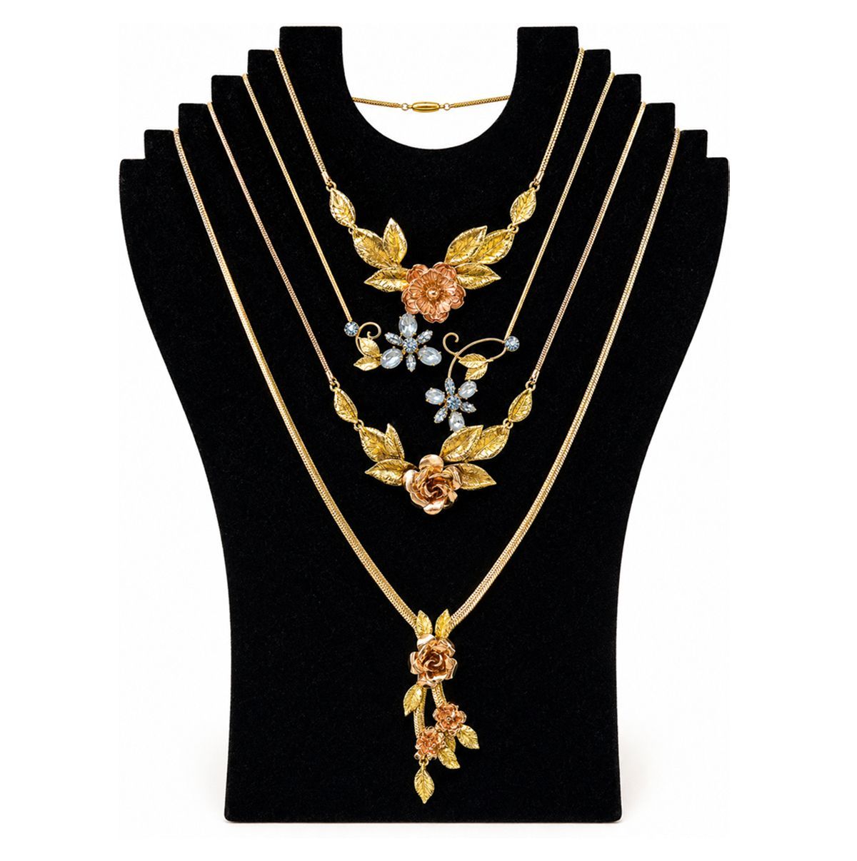 Black velvet necklace display with layered gold necklaces and floral pendants