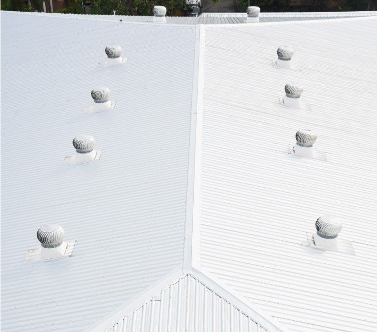 White metal roof with multiple circular vents.