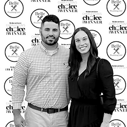 Two people posing in front of a Belleville Choice Awards backdrop, smiling at the camera.