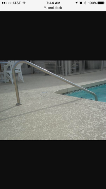 Pool with concrete deck and stainless steel handrail.
