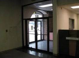 There is a door in the middle of the room that is open.